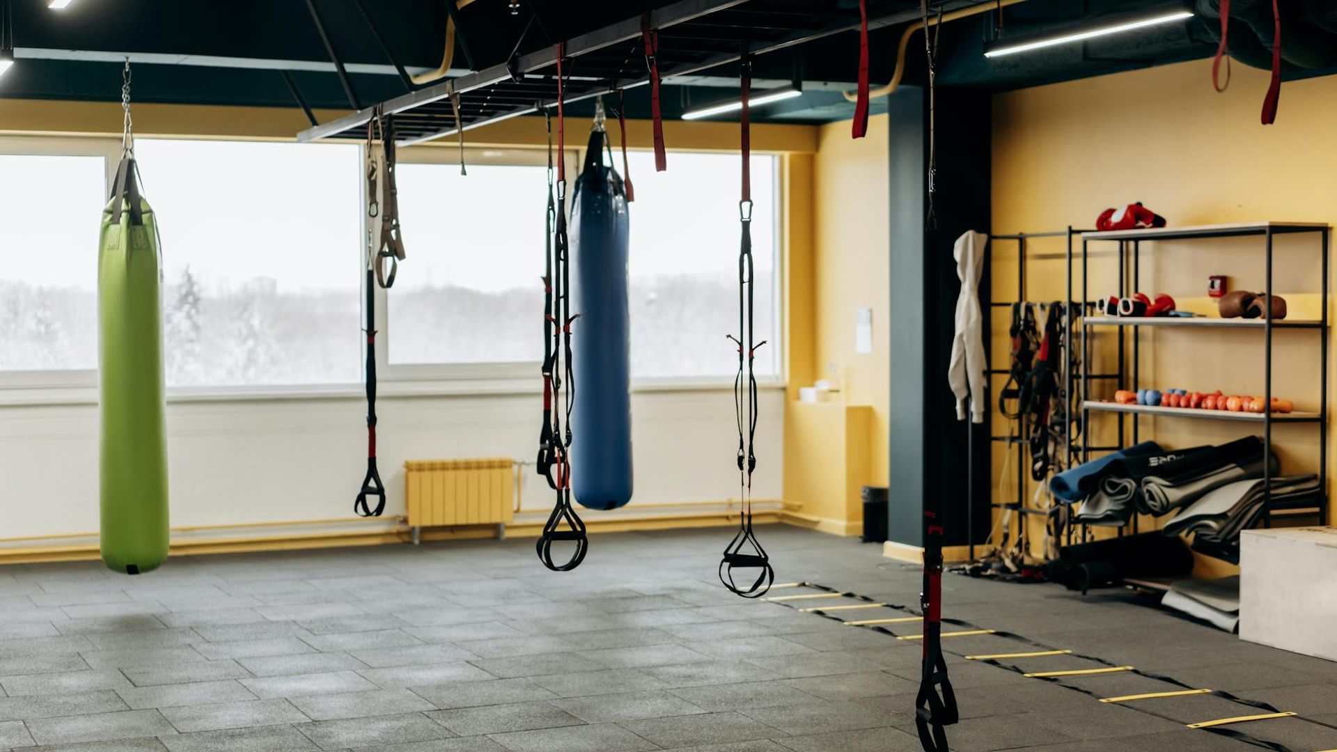 A calm person in a spacious, minimalist room, ready for exercise.